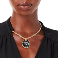 Load image into Gallery viewer, Model wearing a black rhinestone ring pendant necklace with a gold-tone rope chain.