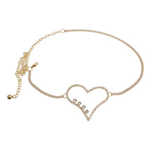 Load image into Gallery viewer, Gold chain belt with a crystal heart centerpiece and clear rhinestones, shown flat