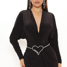 Load image into Gallery viewer, Model wearing the silver rhinestone heart chain belt with a black plunge dress