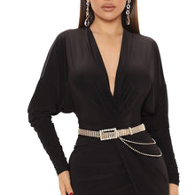 Load image into Gallery viewer, Model wearing the gold stone drape rhinestone buckle belt with a black V-neck dress