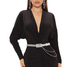 Load image into Gallery viewer, Model wearing the silver stone drape rhinestone buckle belt with a black V-neck dress