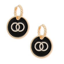 Load image into Gallery viewer, Pair of gold-tone twisted hoop earrings with black rhinestone ring charms on a white background
